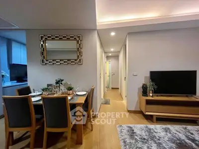 Modern living room with dining area and stylish decor in a cozy apartment setting.