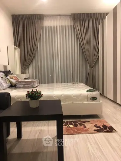 Modern bedroom with elegant curtains and stylish furniture, perfect for a cozy and comfortable living space.