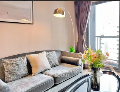 Stylish living room with plush sofa and elegant decor in modern apartment.