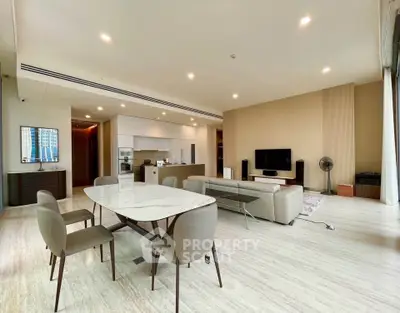 Spacious modern living room with open kitchen and elegant dining area.