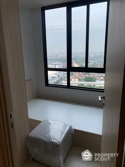 Cozy small room with window seat offering panoramic city view