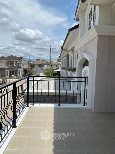 Spacious balcony with elegant railing and scenic neighborhood view