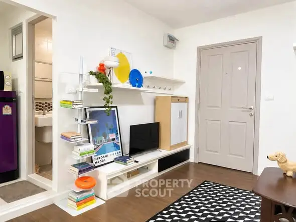 Charming living room with modern decor and ample storage in cozy apartment.