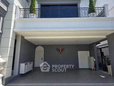 Elegant modern building exterior with spacious covered parking area and stylish balcony.