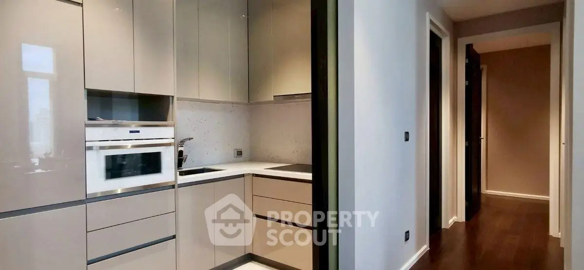 Modern kitchen with sleek cabinetry and built-in appliances in a stylish apartment.