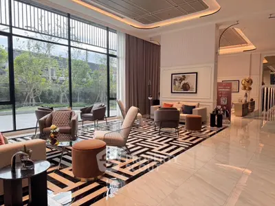 Luxurious modern living room with elegant decor and large windows offering garden views.