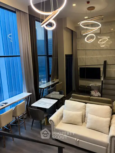 Luxurious modern living room with high ceilings and stylish lighting in a contemporary apartment.