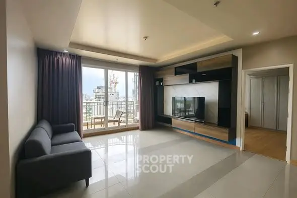 Spacious modern living room with large windows and balcony access