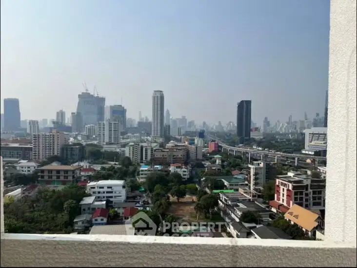 Stunning cityscape view from a high-rise balcony showcasing urban skyline and vibrant city life.