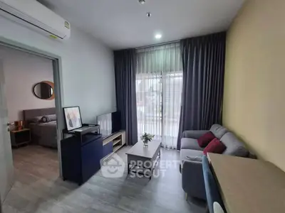 Modern living room with cozy sofa and large window in stylish apartment