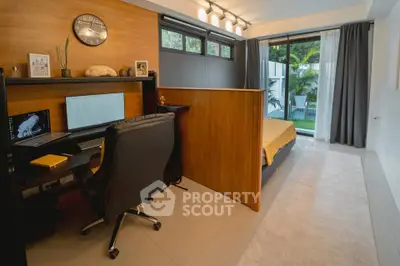 Modern bedroom with study area and garden view, featuring sleek design and natural light.