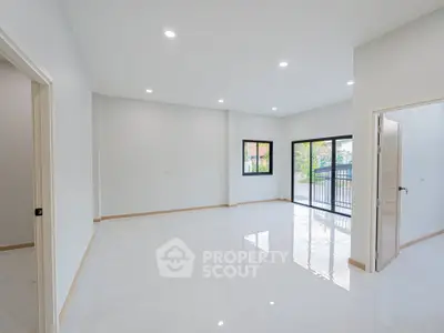 Spacious modern living room with large windows and bright natural light