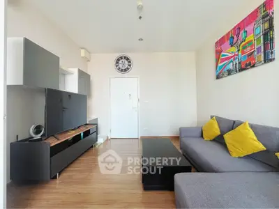 Modern living room with stylish decor and comfortable seating in a bright apartment.