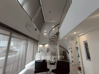 Stunning modern living room with spiral staircase and large windows