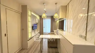 Modern living room with elegant lighting and sleek marble accents