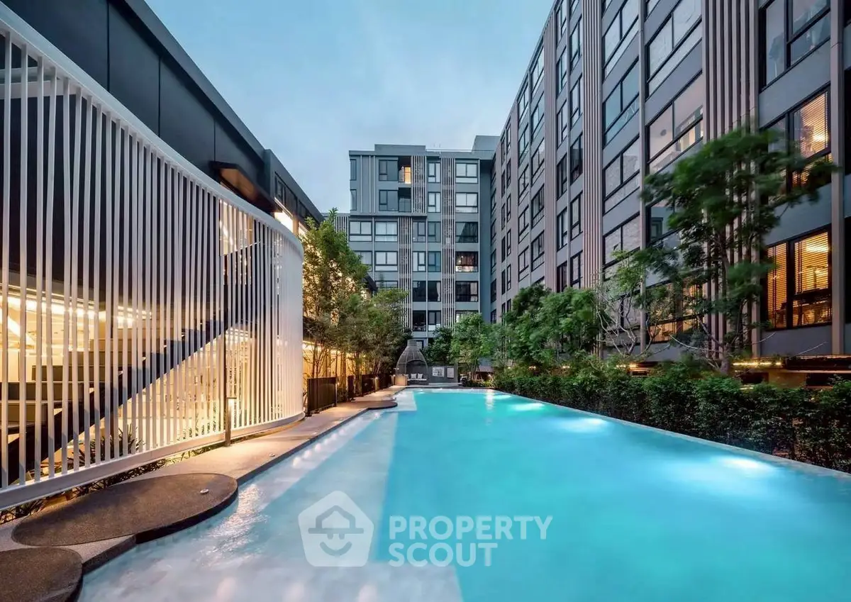 Luxurious modern apartment complex with stunning pool and lush greenery