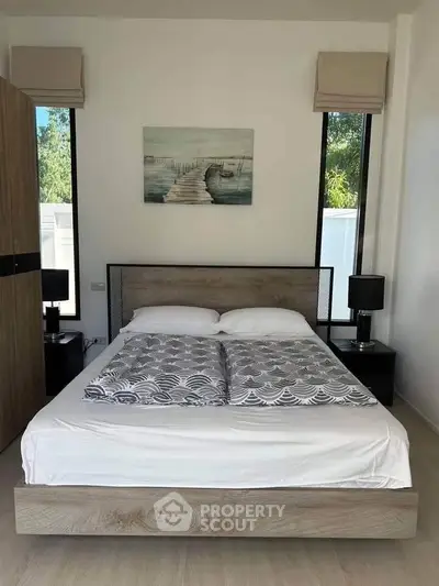 Modern bedroom with stylish decor and natural light, featuring a cozy bed and elegant furnishings.