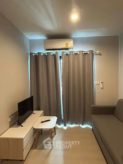Cozy living room with modern air conditioning and sleek furniture, perfect for relaxation and entertainment.