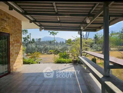 Spacious patio with scenic garden view and modern stone wall design