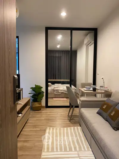 Modern living room with cozy sofa and stylish decor in open-plan apartment