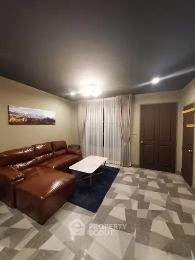 Modern living room with brown leather sofa and geometric floor tiles