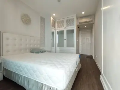 Spacious bedroom with elegant white decor and ample storage space