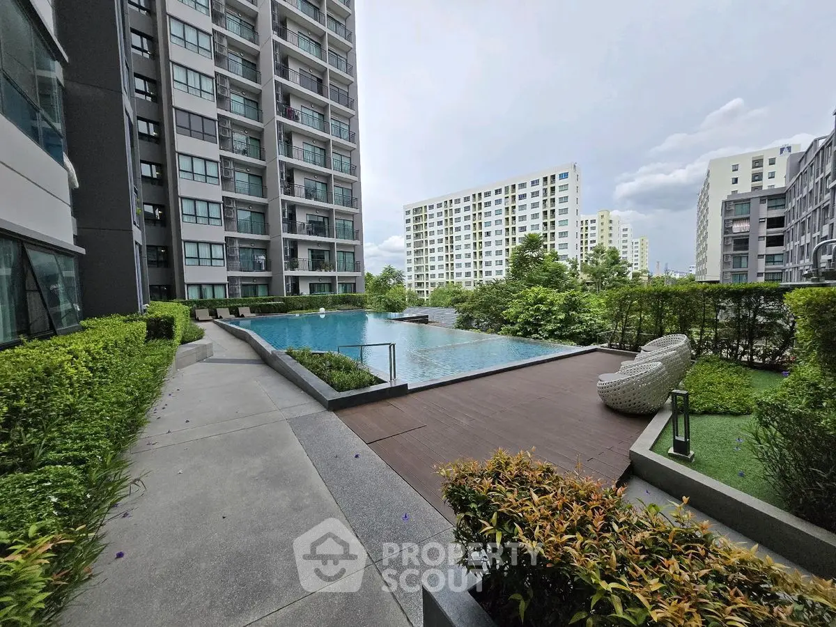 Modern apartment complex with luxurious pool and lush greenery