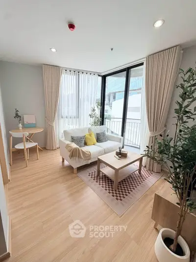Bright and modern living room with large windows and stylish decor in a contemporary apartment.