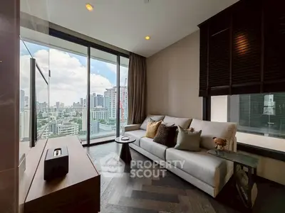 Modern living room with city view, stylish furniture, and large windows in urban apartment.