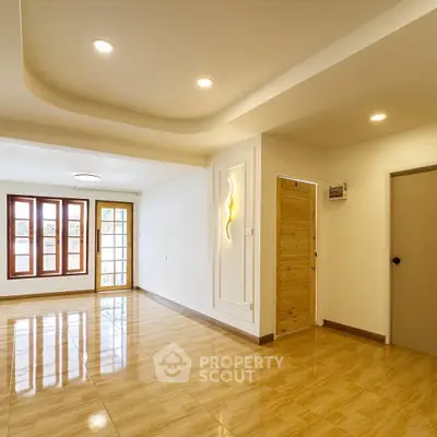 Spacious modern living room with wooden flooring and large windows