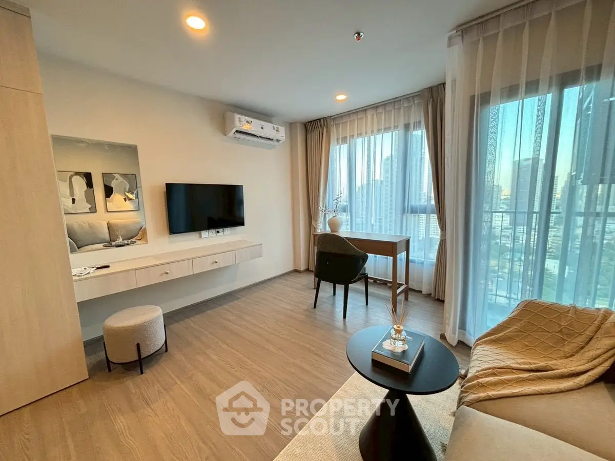 Modern living room with city view, stylish decor, and natural light.