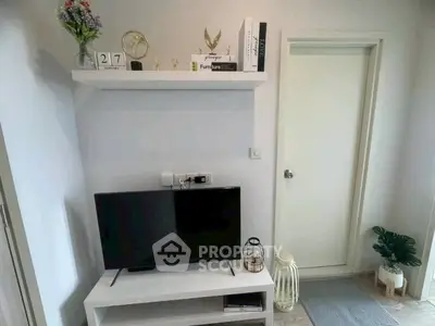 Modern living room with stylish decor and flat-screen TV on a sleek white stand.