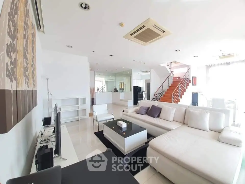 Luxurious modern living room with white sectional sofa and elegant decor