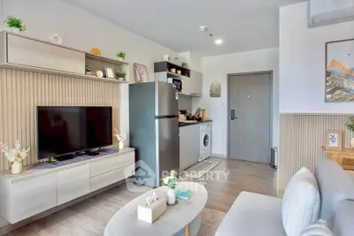 Modern living room with integrated kitchen, featuring sleek appliances and stylish decor.
