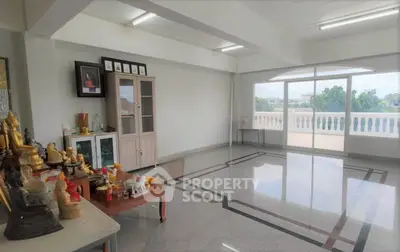 Spacious room with elegant flooring and balcony access, ideal for versatile living or office space.