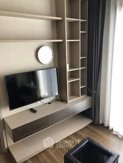 Modern living room with sleek TV unit and stylish shelving, perfect for contemporary urban living.
