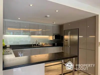 Sleek modern kitchen with stainless steel appliances, ample cabinetry, and a large island perfect for entertaining guests.