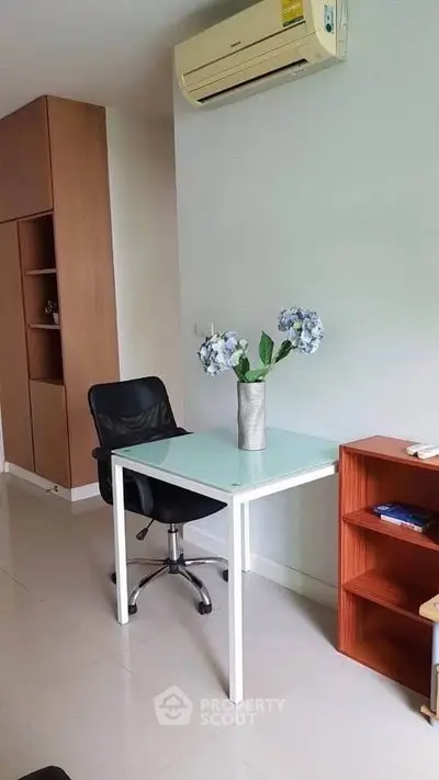 Modern study area with sleek desk, chair, and air conditioning in a stylish apartment.