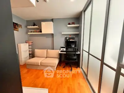 Modern study room with sleek design and ample natural light, featuring a cozy sofa and stylish desk setup.