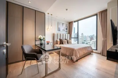 Luxurious bedroom with city view, elegant decor, and modern furnishings in high-rise apartment.