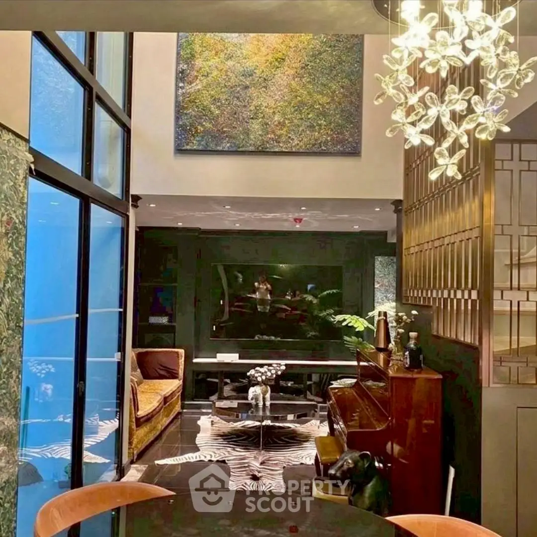 Luxurious living room with high ceilings, elegant decor, and modern lighting in a stylish home.