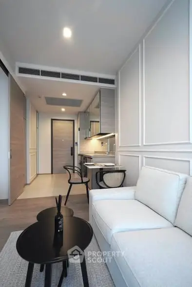 Modern living room with sleek design and cozy furniture in a stylish apartment.