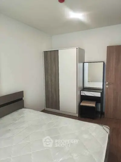 Cozy bedroom with modern wardrobe and dressing table, perfect for a minimalist lifestyle.