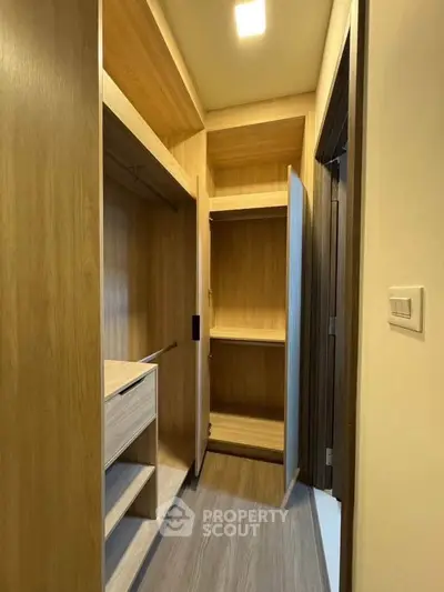 Spacious walk-in closet with wooden finish and ample storage space.