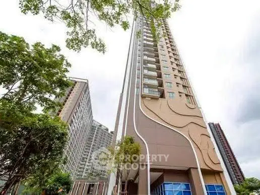 Stunning modern high-rise building with unique architectural design and lush greenery.