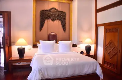 Luxurious bedroom with elegant decor and plush bedding in a serene setting.