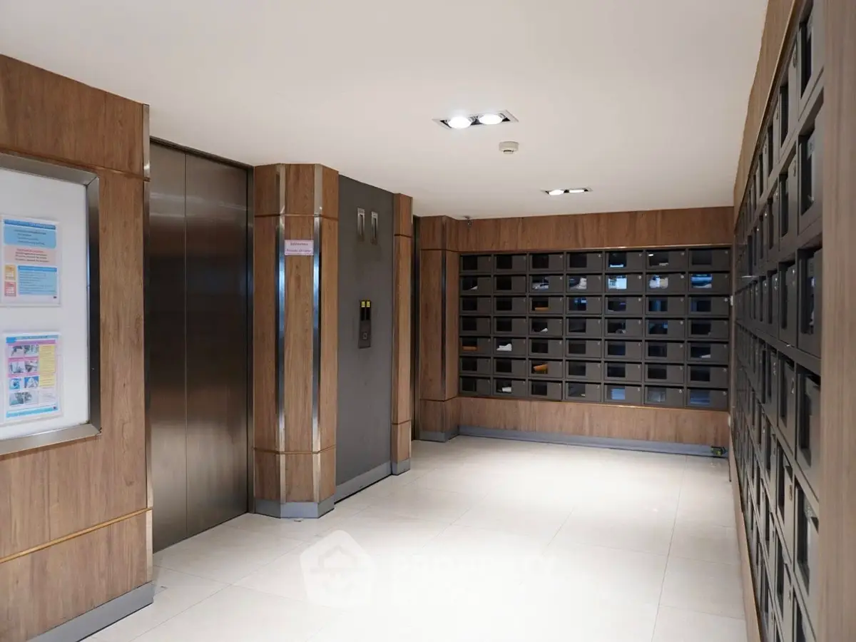 Modern apartment building lobby with elevator and mailboxes