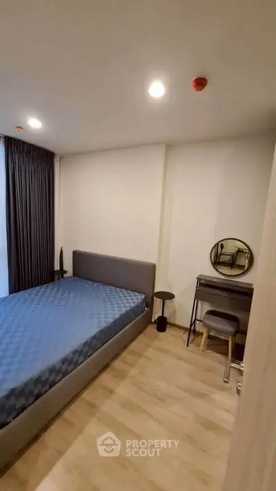 Modern bedroom with stylish furniture and natural light, perfect for a cozy living experience.