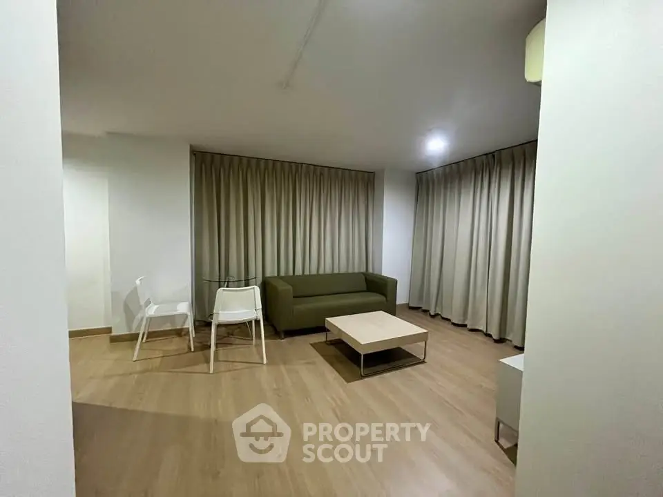 Modern living room with minimalist furniture and wooden flooring, perfect for cozy gatherings.