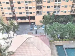 Aerial view of residential building with parking and pool area surrounded by palm trees.